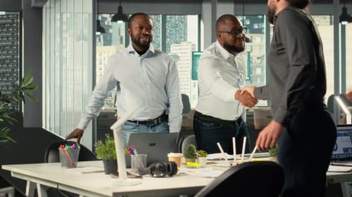 Business Professionals Meeting and Shaking Hands in Modern Office