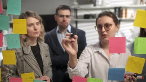 Business Team Brainstorming with Sticky Notes in Office