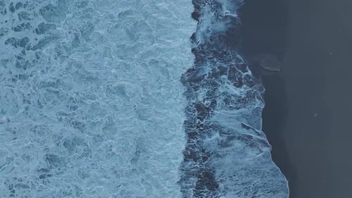 Aerial Video Stormy Waves Hitting the Coastline with Stunning Foam and Beach Views
