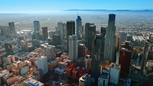 Downtown of beautiful Los Angeles on sunny morning. City at backdrop is covered with thick fog
