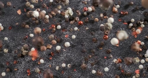 Mixed peppercorns in a super slow motion. Dry mix peppercorns close up.