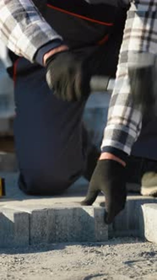 Construction Worker Leveling Pavement Bricks Outdoors