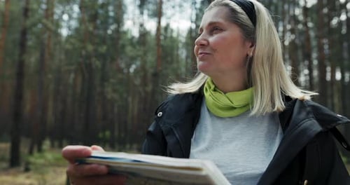 Woman Studies Map in Forest