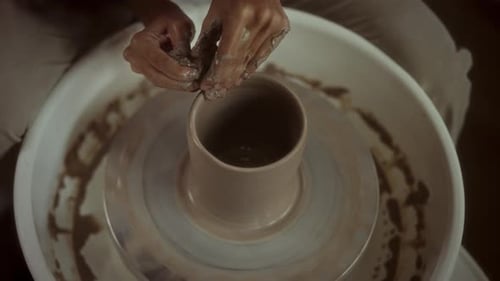 Hands Shaping Clay on a Pottery Wheel