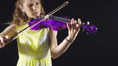 Talented female violinist playing the violin in the studio. Musician.