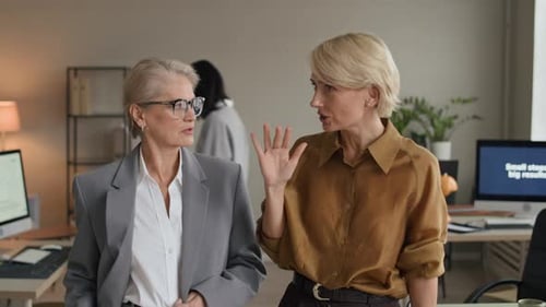 Successful Businesswomen Discussing Project in Modern Office