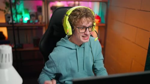 Man Playing Online Game at Computer Desk