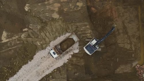 Aerial View of Excavator Loading Dump Truck With Dirt