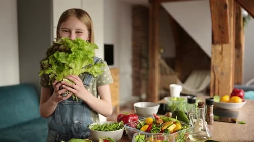 Cute Little Smiling Girl Playing With A Fresh Green Salad