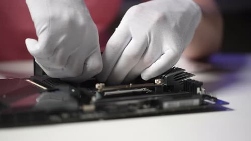 Closeup Cropped Shot of Unrecognizable Professional Repairman in Gloves Screwing in PC CPU Air