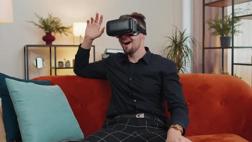 Man Enjoys Virtual Reality on Couch with VR Headset