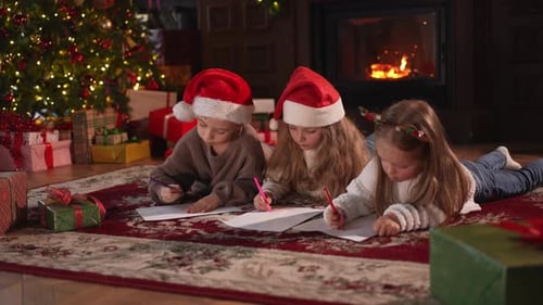 Children Drawing Christmas Wish List by Cozy Fireplace
