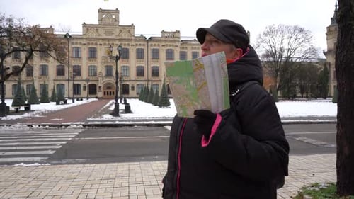 Elderly Woman Tour Guide Tells a Story Standing on the Urban City Street A Grandmother Walks in
