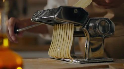 Handmade, Young white housewife in motion Cooking spaghetti with her hands by hand