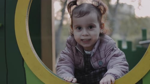 Happy Toddler Girl Stands on the Playground Looking at Camera Family Child and Healthy Lifestyle