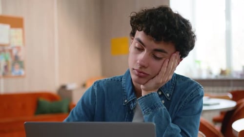 Caucasian Tired Bored Male Student Fatigued Boy in School Studying Online Laptop Upset Sleepy Man
