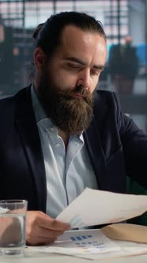 Vertical Video Male Professional Analyzes Performance Data and KPIs Metrics for Decision Making