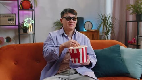 Man Watching TV at Home with Popcorn