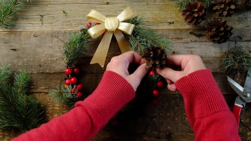 Festive Holiday Wreath Creation on Rustic Wood Table