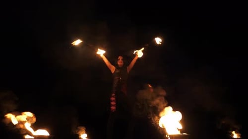 A Professional Artist Demonstrates Various Fire Tricks A Fire Show