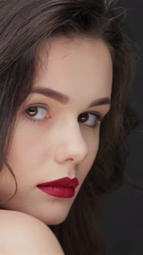 Beautiful Brunette Woman Posing with Red Lipstick