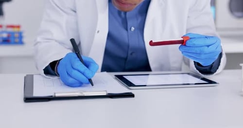 Scientist Examines Blood Samples in a Lab