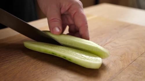 07/ Fresh cucumber is cut into pieces for cooking. Cooking cucumber dishes