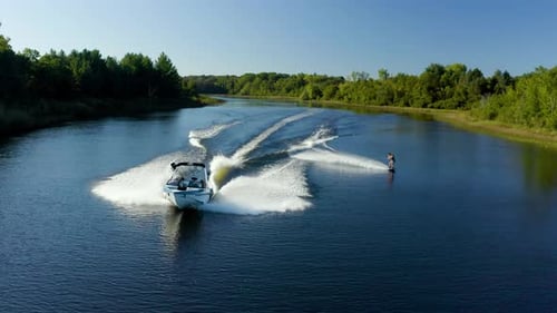 Wakeboarding behind a boat on a lake in Michigan