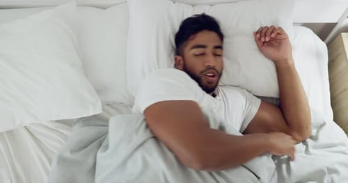 Sleeping, restless and turning with indian man in bed for stress, depression