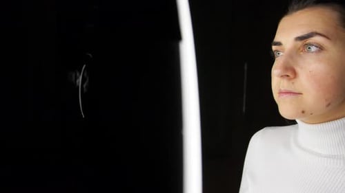 Young Woman Putting on Glasses by Ring Light