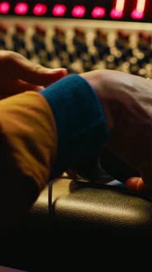 Vertical Video African American Sound Engineer Using Headphones to Listen to Audio Recordings