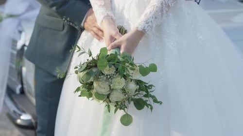 Bride and Groom Embrace at Wedding with Bouquet