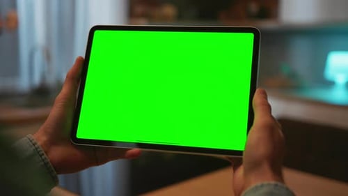 View of Isolated Male Left Hand Holding Digital Tablet with Green Screen Unrecognizable Caucasian