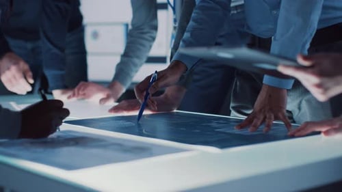 Team Plans at Light Table in Modern Office