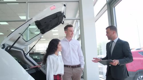 A Young Family Buys a New Car at a Dealership Rent a Car