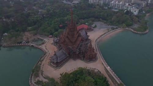 Sunset light shines on oceanfront Sanctuary of Truth pagoda, Thailand