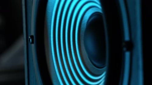 Bass Loudspeaker Moving While Playing Music In Blue Light