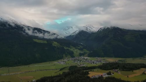 Aerial drone hyper time lapse at a mountain valley in the Austrian alps with fields, trees and sceni