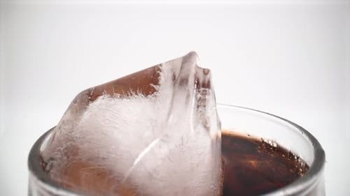 Cola in a glass with ice close up isolated 4K