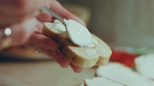 Spreading Cream Cheese on Toast for Snack
