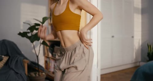 Close Up of Girl in Wide Pants Dancing Dancehall and Having Fun at Home in a Modern Cozy Apartment