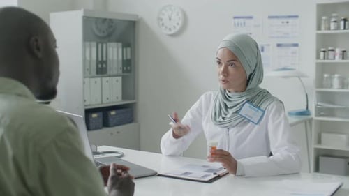 Doctor Explains Medication to Patient in Clinic