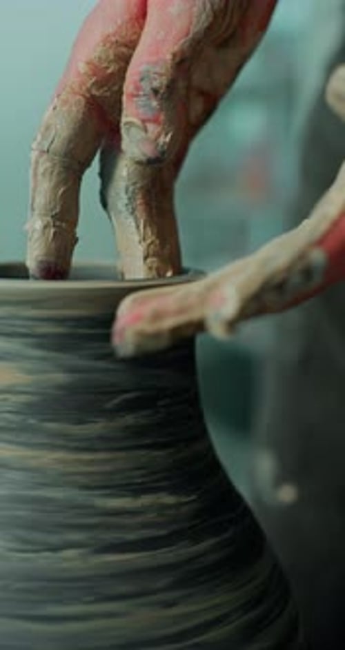 Hands Shaping Clay on Pottery Wheel