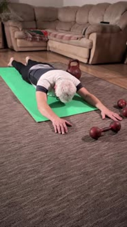 Man Does Leg Raises on Yoga Mat at Home
