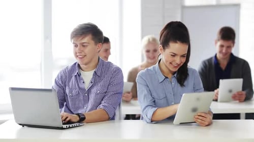 Education, New Technology and School Concept - Students in Computer Class Advice