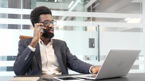 Professional Man Working in Modern Office on Phone