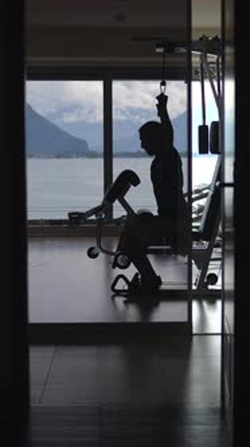 Engaging in a Silhouette Workout By the Window Embracing Both Fitness and Nature Together