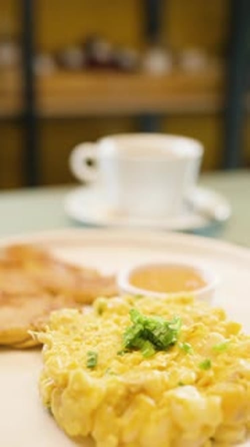 Breakfast Plate with Scrambled Eggs, Toast, and Coffee