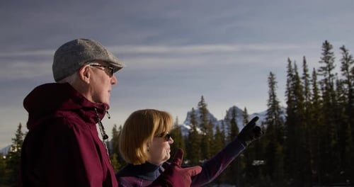 Senior Couple Hing in Sunny Mountain Woods Active Seniors