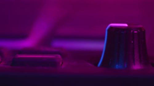 Closeup of a Musician Hands Making Electronic Music DJ Sound Control Console for Mixing Dance Music